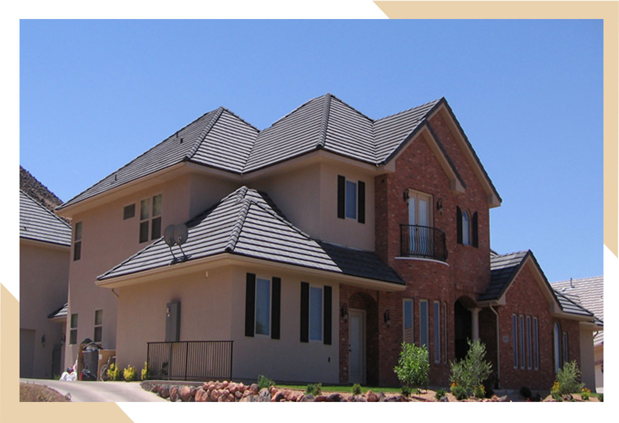 Two story home with tiled roof installed by stout roofing.