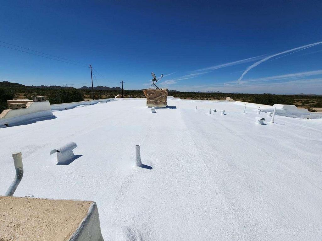 Flat roof spray coating on home in mese arizona.